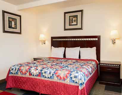 King bed at Whispering Palms Inn